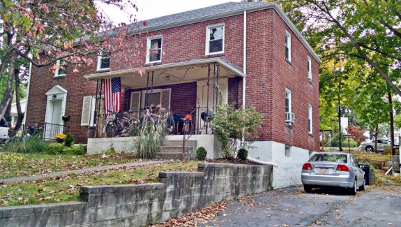 a car parked in front of a brick house