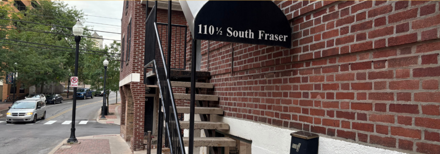 a brick building with a sign that says apply now for 2020 - 2021