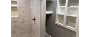 a walk in shower sitting next to a white toilet