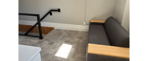 a room with a couch and some stairs