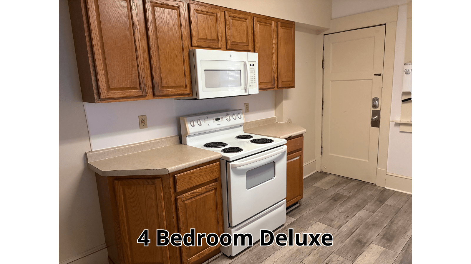 Kitchen with white stove and wood cabinets