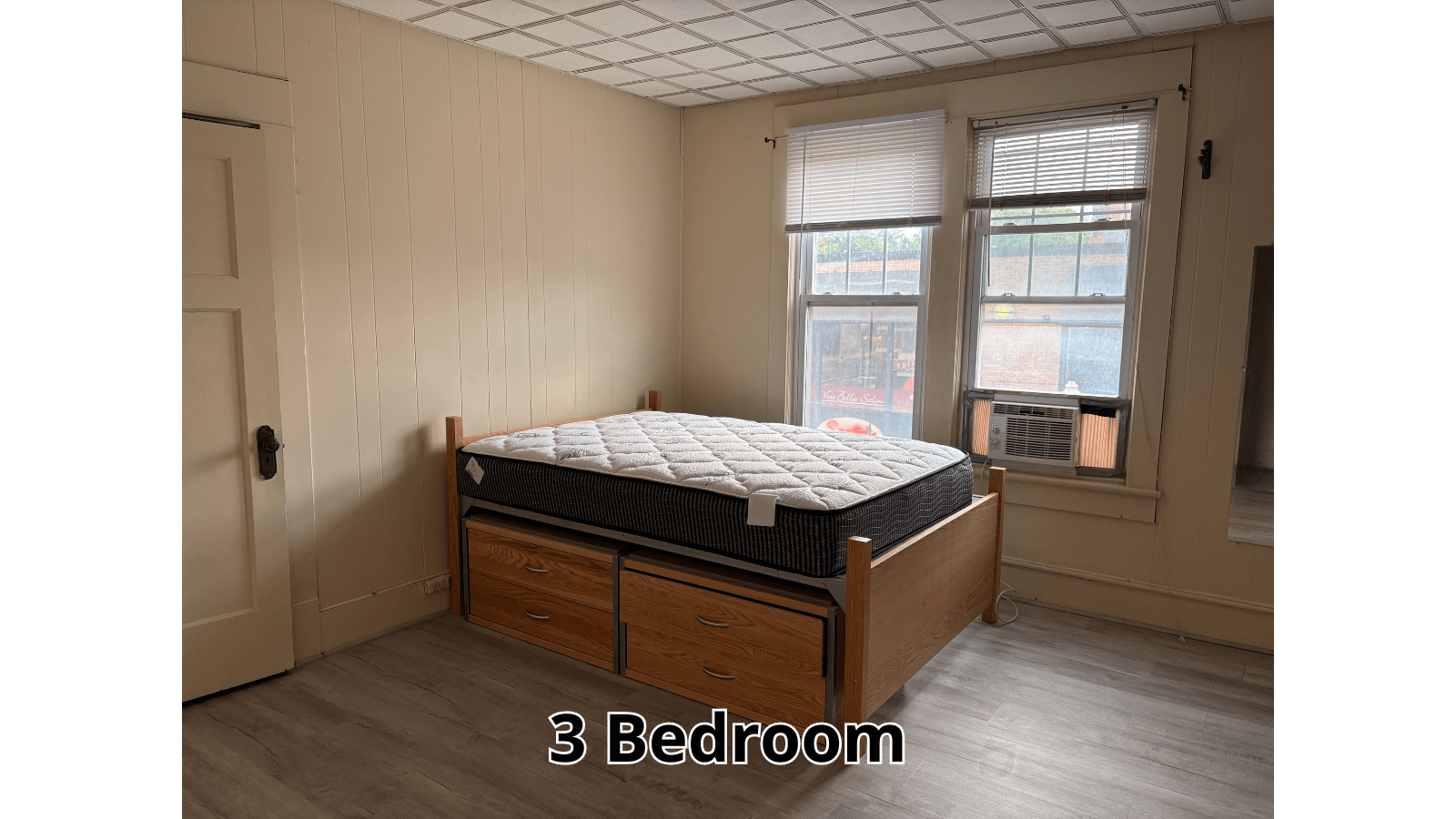 Bedroom with bed, dresser, and window