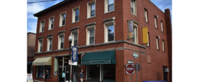 a red brick building on the corner of a street