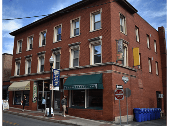 a red brick building on the corner of a street