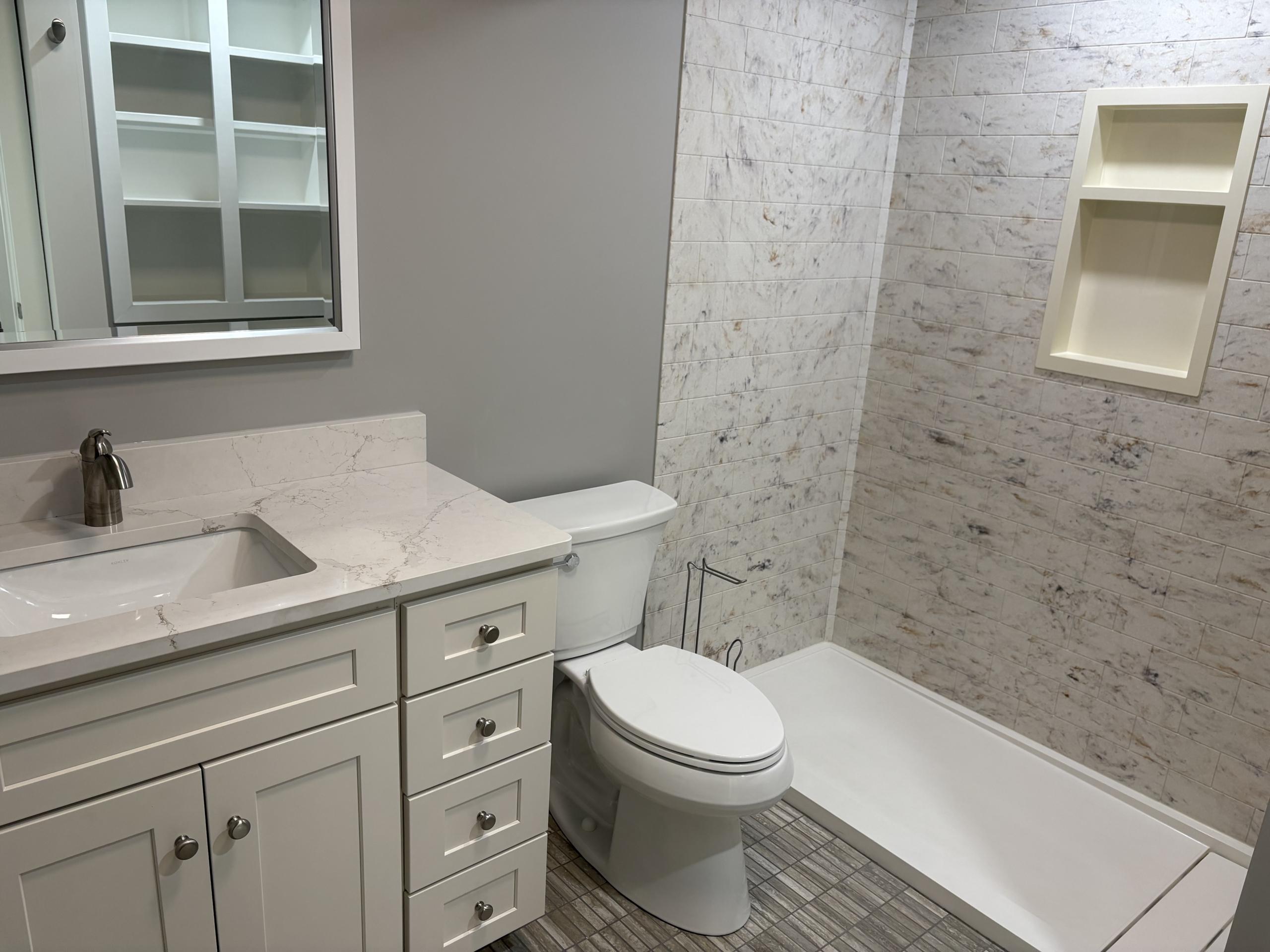 Modern bathroom vanity, toilet, and shower