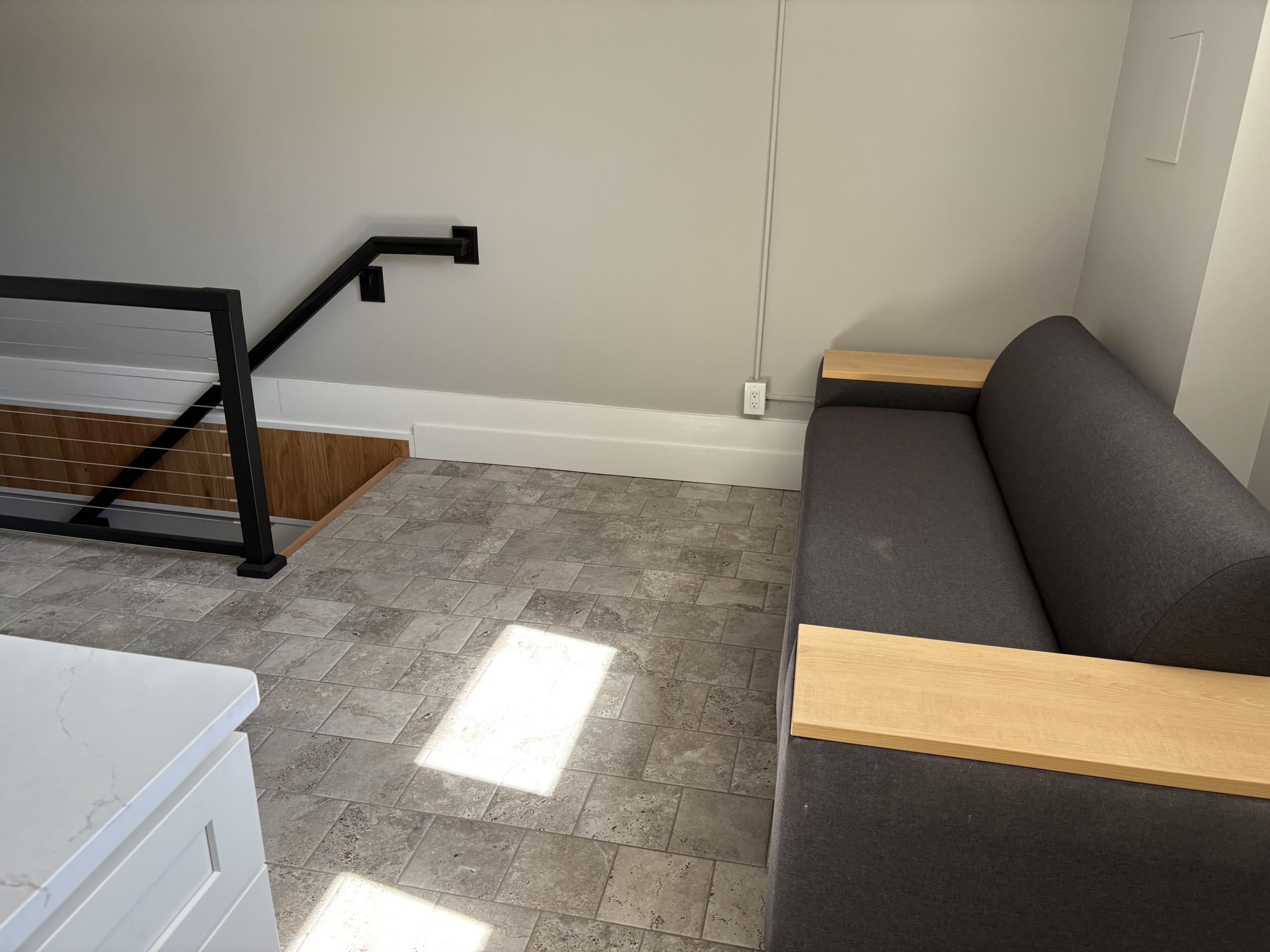 Modern couch and stairs in bright room