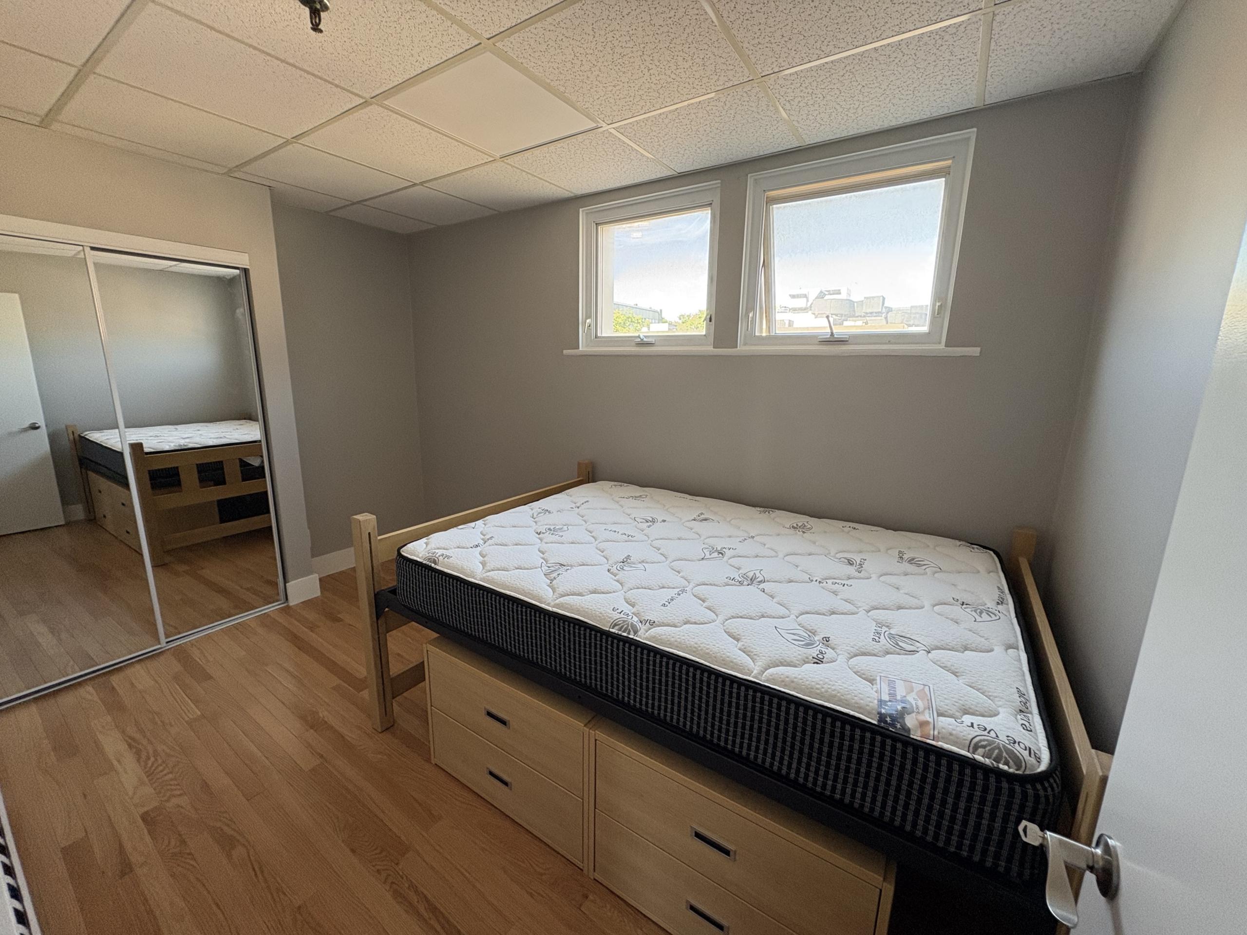 Bedroom with bed, windows, and closet