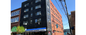 an apartment building on the corner of a street