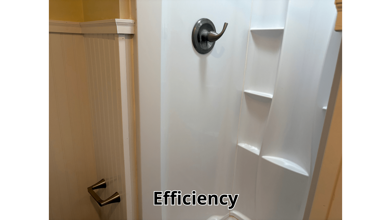 Shower stall with white walls and bronze fixtures