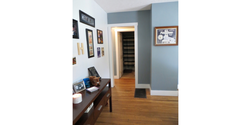 Entryway with table and pictures