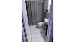 Bathroom with toilet, pedestal sink and tub/shower combo