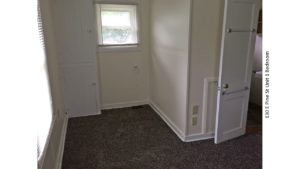 Unfurnished, carpeted bedroom with built in cabinet