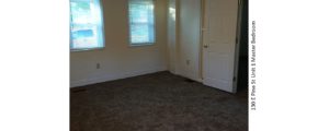 Unfurnished, carpeted bedroom with two windows