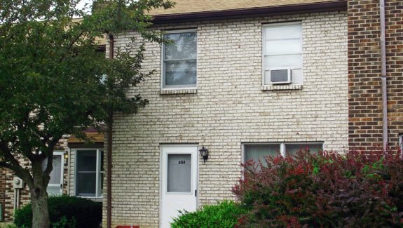 a brick building with a white door and windows