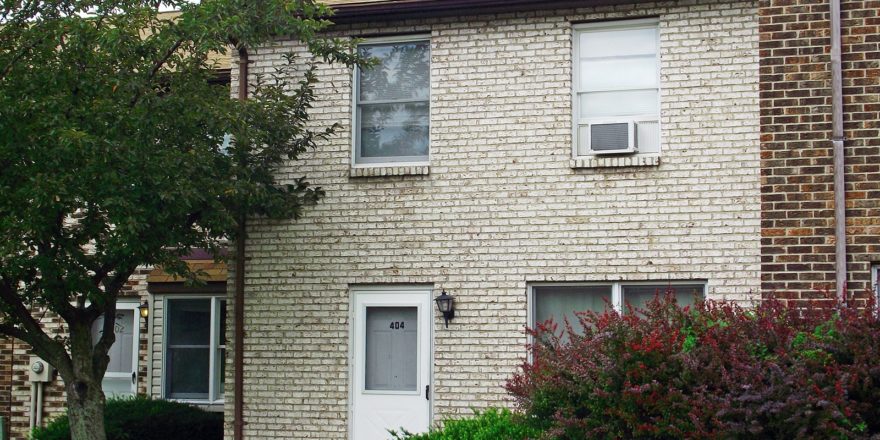 a brick building with a white door and windows