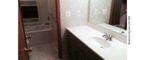 Bathroom with large vanity, tub/shower combo, and toilet