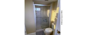Bathroom with toilet and shower stall