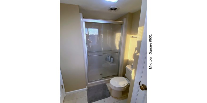 Bathroom with toilet and shower stall