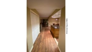 Hallway with views into kitchen, dining area, and living room