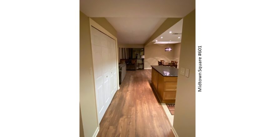 Hallway with views into kitchen, dining area, and living room