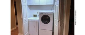 Laundry closet with washer/dryer and cabinets above the machines