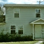 Exterior of house with siding and covered front porch
