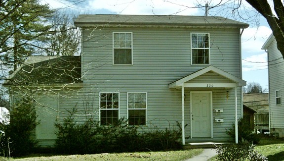 Exterior of house with siding and covered front porch