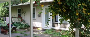 Exterior of ranch house with tan large panel siding