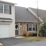 Exterior of townhome with stone front and steep pitched roof