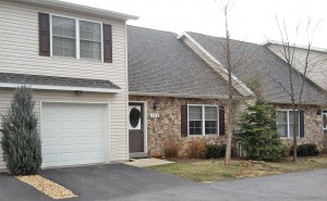 Exterior of townhome with stone front and steep pitched roof