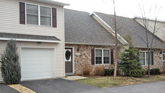 Exterior of townhome with stone front and steep pitched roof