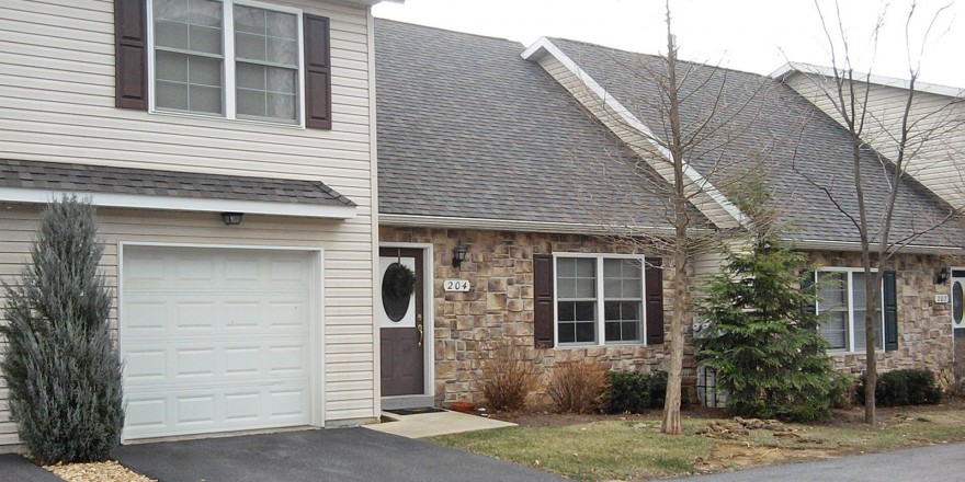 Exterior of townhome with stone front and steep pitched roof