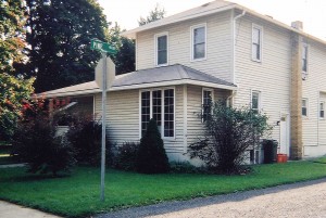 Exterior of two-story house with siding and back porch