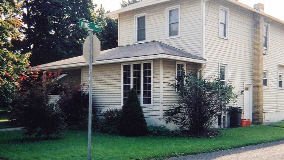 Exterior of two-story house with siding and back porch