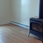 Living room with wood floor and wood-burning fireplace