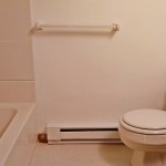 Bathroom with white shower/tub combo, white toilet, and vanity