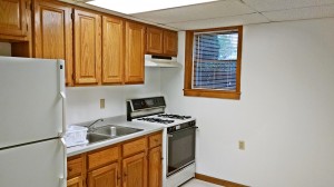 Kitchen with wooden cabinets and white appliances.