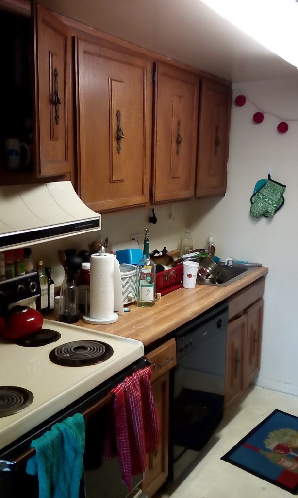 Kitchen with wood cabinets and mixed color of appliances