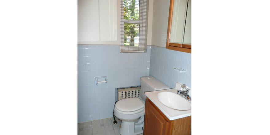 Bathroom with vanity, toilet, and medicine cabinet