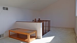 Multi-purpose attic office space. Stairs coming up in to the middle of the room.