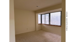 Unfurnished, carpeted bedroom with large windows