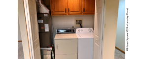 Laundry closet with side-by-side front load washer and top load dryer with cabinets