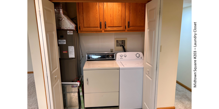 Laundry closet with side-by-side front load washer and top load dryer with cabinets