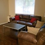 Living room with couches, accent tables, and lamp