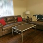 Living room with couches, accent tables, and lamp