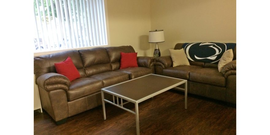 Living room with couches, accent tables, and lamp