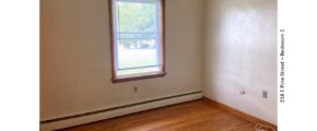Unfurnished bedroom with hardwood floors and window