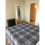 Bedroom with large bed and chest of drawers
