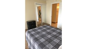 Bedroom with large bed and chest of drawers