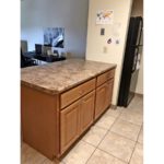 Kitchen island and black fridge